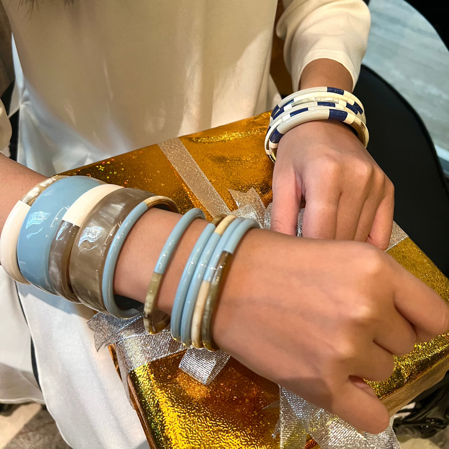 Ajoutez une touche d'élégance à votre collection de bijoux avec le sublime jonc laqué en corne naturelle "Chacha d'Amour". Ce bracelet unique, d'une délicate teinte BLEU CIEL, allie artisanat traditionnel et modernité, offrant une pièce d'exception pour toutes les occasions. Fabriqué à partir de corne 100% naturelle, chaque jonc est soigneusement travaillé à la main, garantissant ainsi un design original et authentique. Que ce soit pour un look quotidien ou une occasion spéciale, le jonc "Chacha d'Amour"